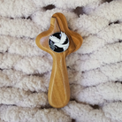 Olive wood holding cross with dove Holy Spirit medallion on blanket